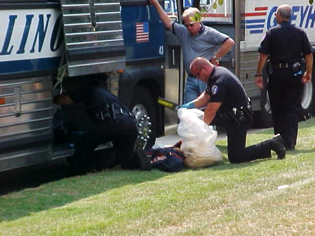 Police officers unload the buses.